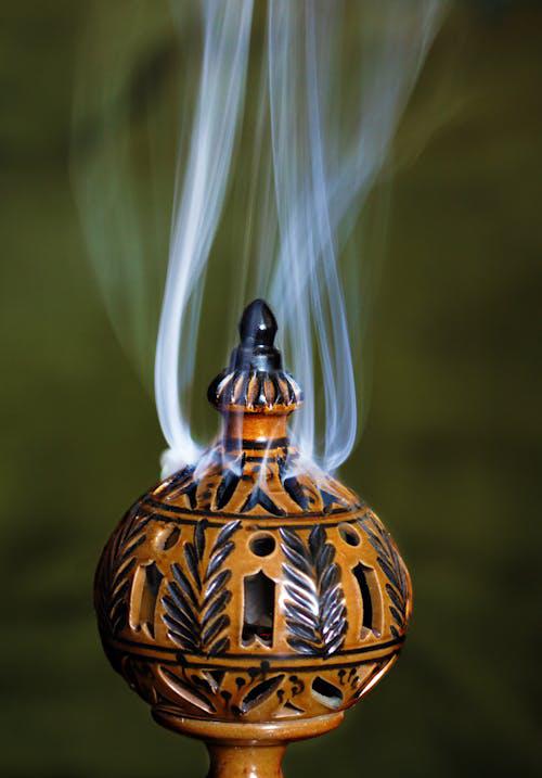 Traditional incense smoke rising from a carved burner