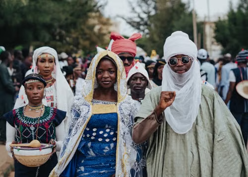 People gathered in traditional dress at a community celebration